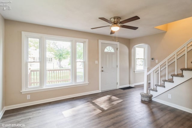 foyer entrance with ceiling fan and dark hardwood / wood-style floors