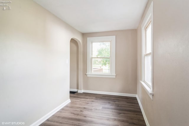 empty room with dark hardwood / wood-style floors