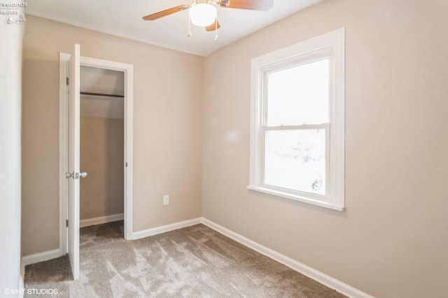 unfurnished bedroom with light colored carpet and ceiling fan