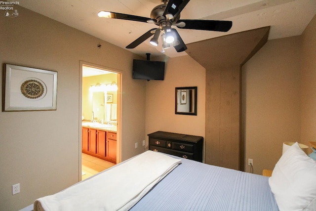 bedroom featuring connected bathroom, ceiling fan, and sink