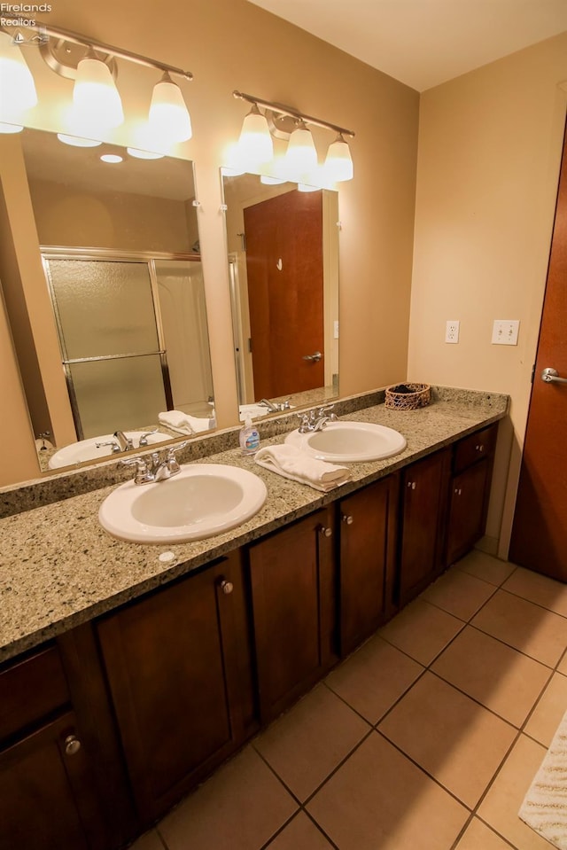 bathroom featuring tile patterned floors, vanity, and walk in shower