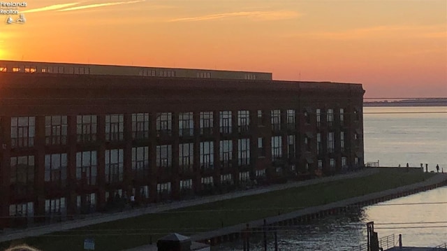 outdoor building at dusk featuring a water view