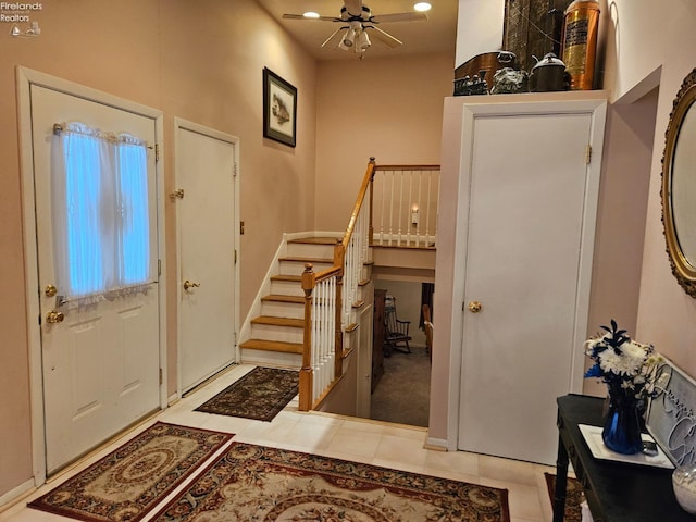 tiled entryway featuring ceiling fan