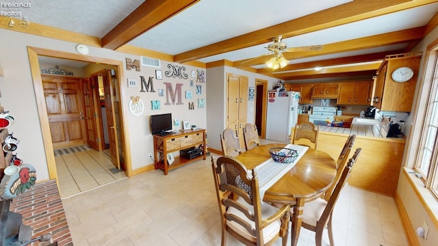 dining area with beam ceiling, ceiling fan, and light tile patterned flooring