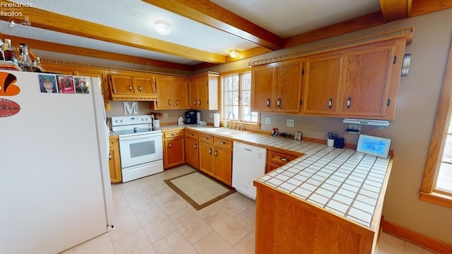 kitchen with kitchen peninsula, white appliances, tile counters, and sink