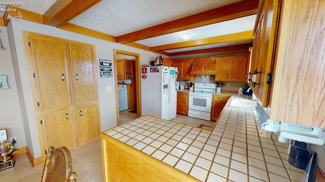 kitchen with tile countertops, sink, beamed ceiling, and white appliances