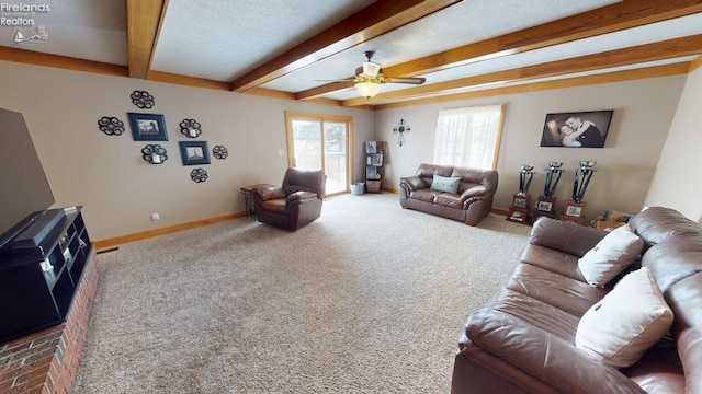 living room featuring carpet, ceiling fan, and beam ceiling