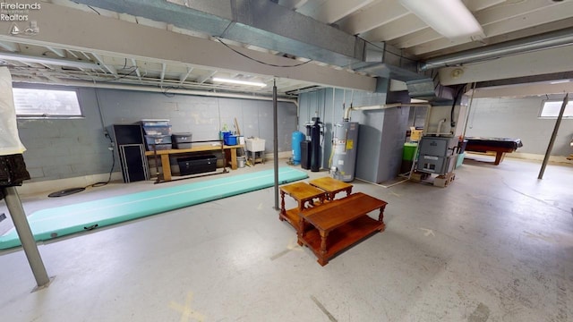 basement with water heater and billiards