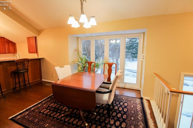 dining room featuring a chandelier, dark hardwood / wood-style floors, and sink