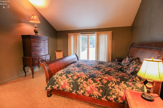 bedroom with lofted ceiling, carpet floors, and access to outside