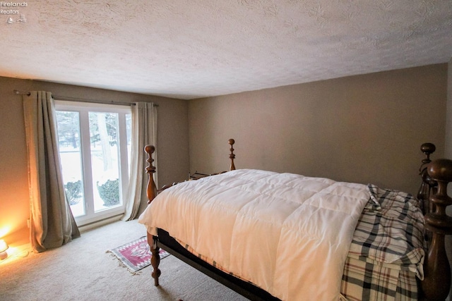 bedroom with carpet and a textured ceiling