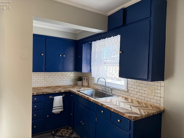 kitchen featuring crown molding, blue cabinets, backsplash, and sink