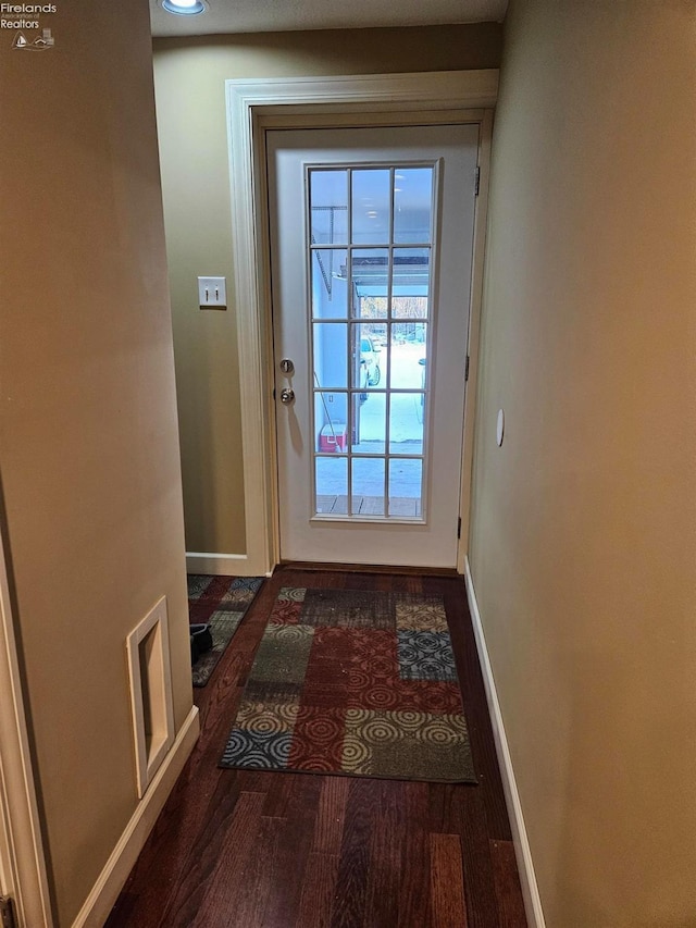 doorway with dark hardwood / wood-style flooring