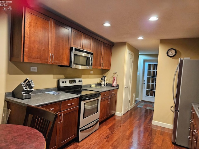 kitchen featuring dark hardwood / wood-style flooring and appliances with stainless steel finishes