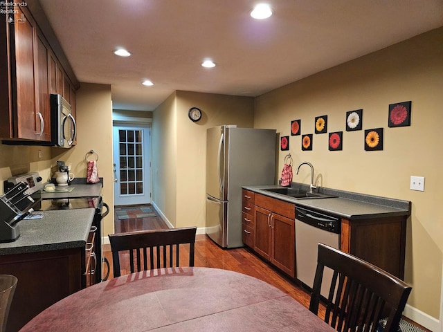 kitchen featuring wood-type flooring, stainless steel appliances, and sink