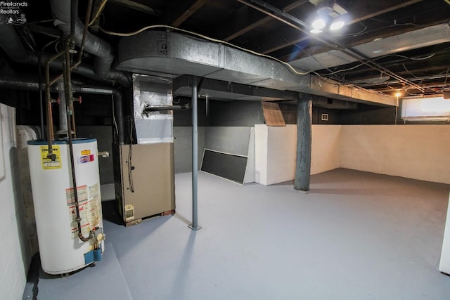 basement featuring heating unit and water heater