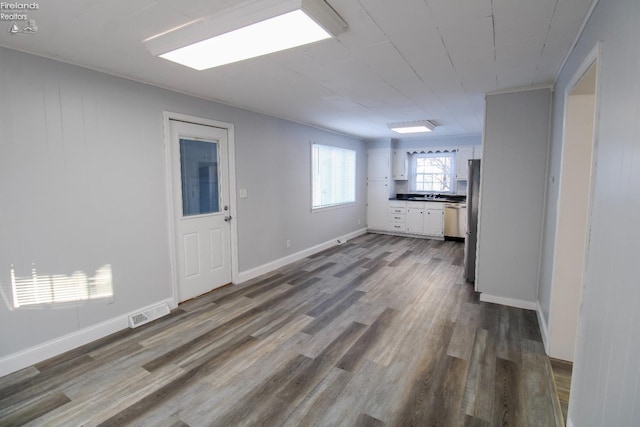 unfurnished living room with wood-type flooring