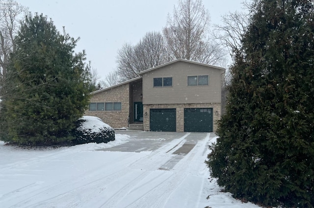 snow covered property featuring a garage