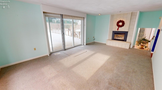 unfurnished living room featuring carpet floors and a fireplace