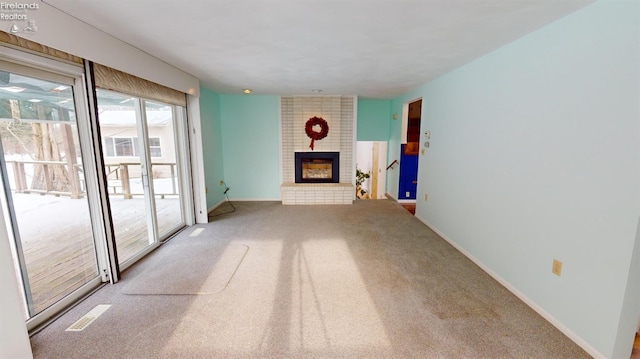 unfurnished living room featuring carpet and a fireplace