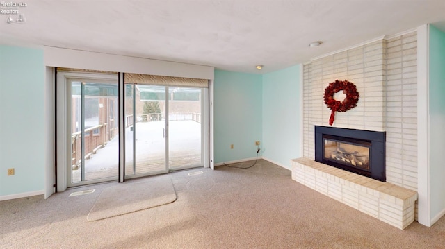 unfurnished living room with carpet flooring and a fireplace