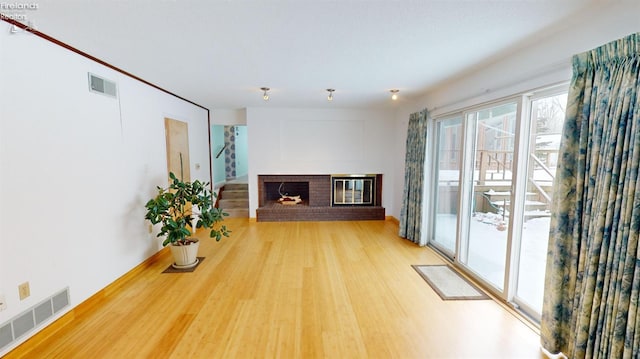 living room with a fireplace and hardwood / wood-style flooring