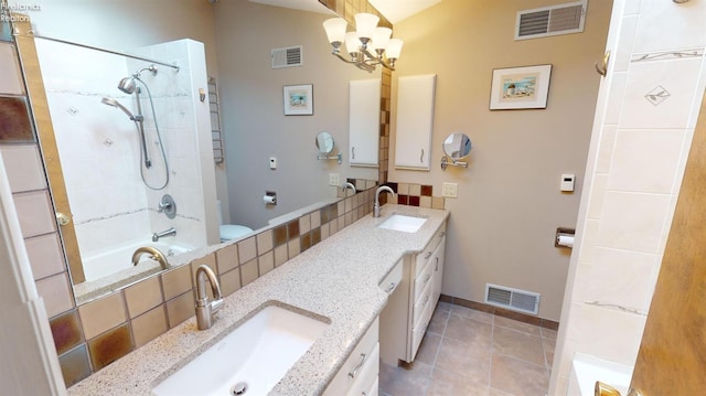 bathroom with tiled shower / bath combo, tile patterned flooring, vanity, an inviting chandelier, and tasteful backsplash