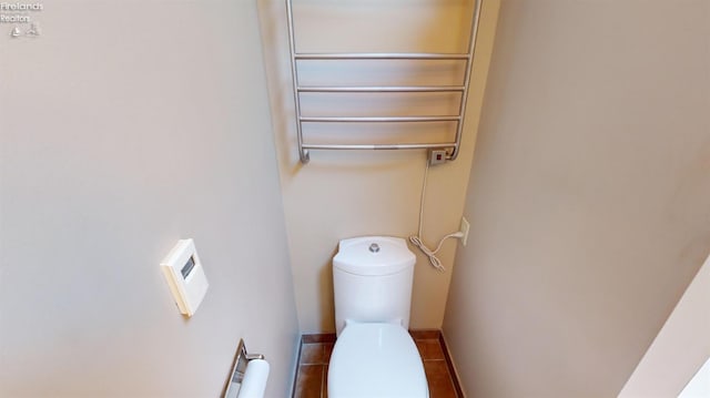 interior details featuring toilet and radiator heating unit