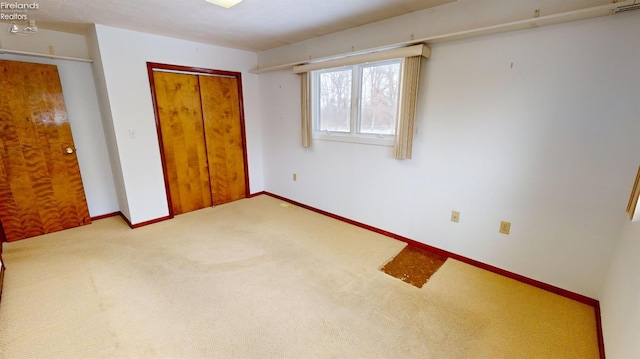 unfurnished bedroom with a closet and carpet