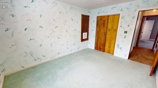 unfurnished bedroom with carpet flooring and a closet