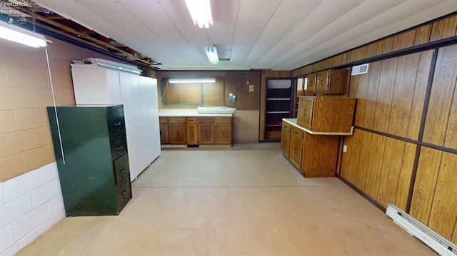 basement with baseboard heating and wood walls