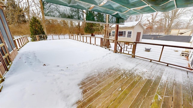 snow covered deck with a storage unit