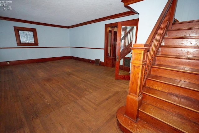 unfurnished room featuring hardwood / wood-style flooring and ornamental molding