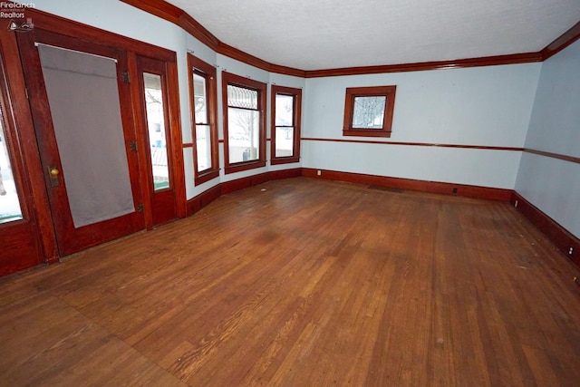 unfurnished room with dark hardwood / wood-style flooring and ornamental molding