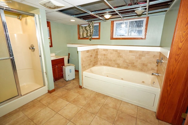 bathroom with tile patterned floors, vanity, and independent shower and bath