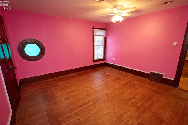 spare room featuring hardwood / wood-style flooring and ceiling fan