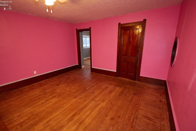 unfurnished room featuring a textured ceiling and hardwood / wood-style flooring