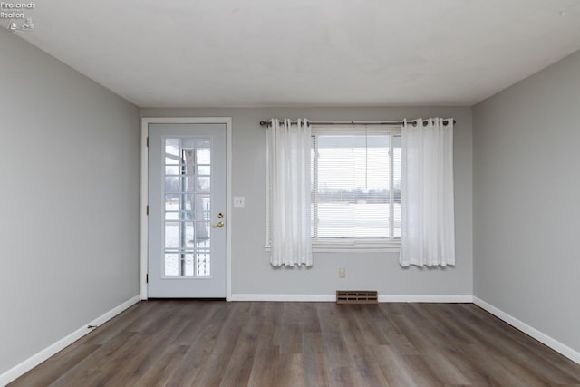 doorway to outside with dark wood-type flooring