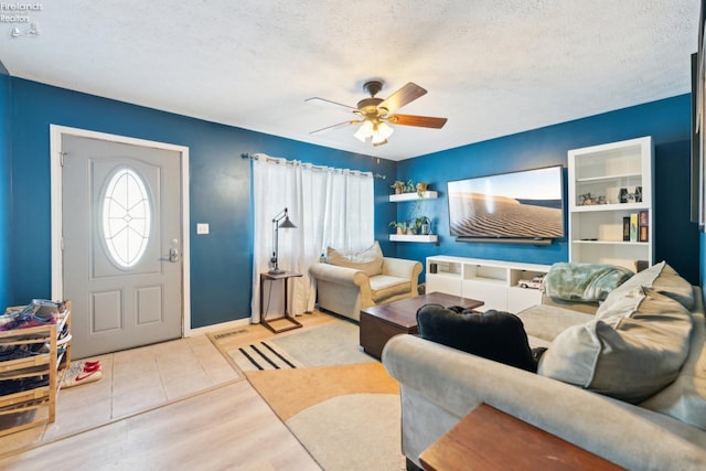 living room featuring a textured ceiling, ceiling fan, and light hardwood / wood-style floors