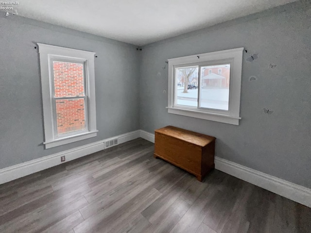 unfurnished room with plenty of natural light and hardwood / wood-style floors