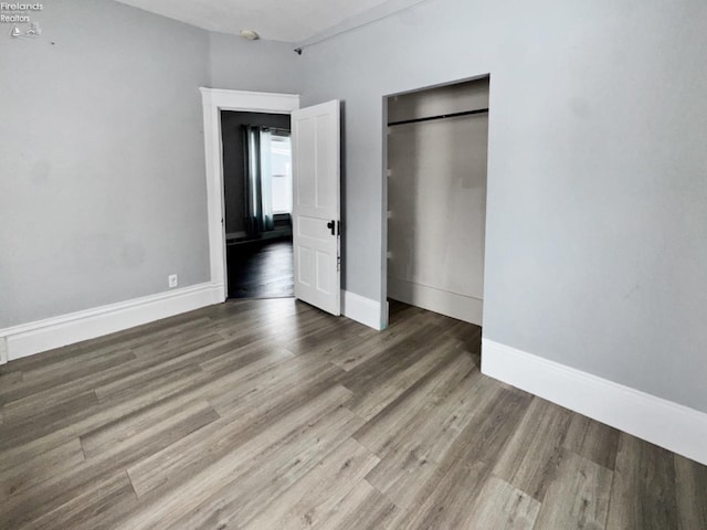 unfurnished bedroom featuring hardwood / wood-style flooring