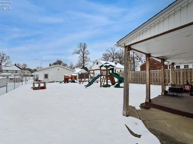 snowy yard with a playground