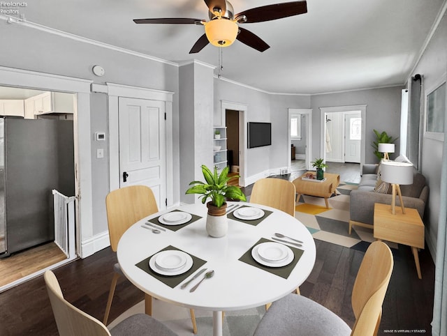 dining room featuring ceiling fan, dark hardwood / wood-style floors, and crown molding