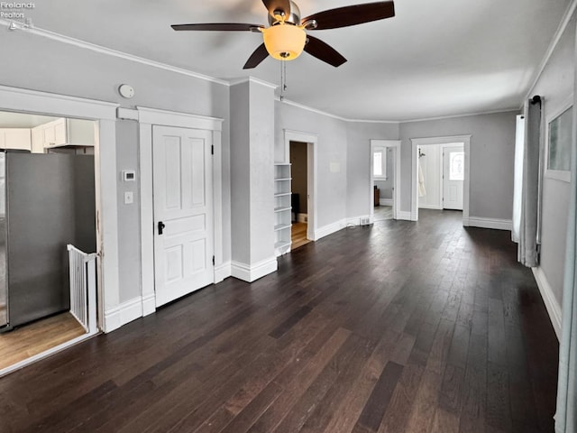 unfurnished living room with ceiling fan, dark wood-type flooring, and crown molding