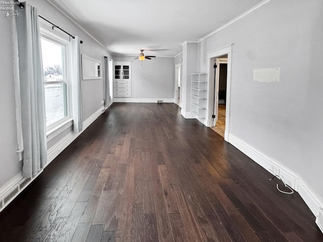 interior space with ceiling fan, dark hardwood / wood-style flooring, and ornamental molding