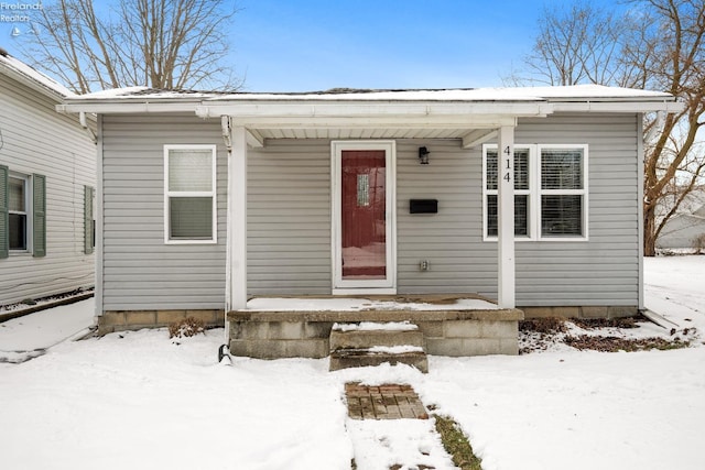 view of snow covered property entrance