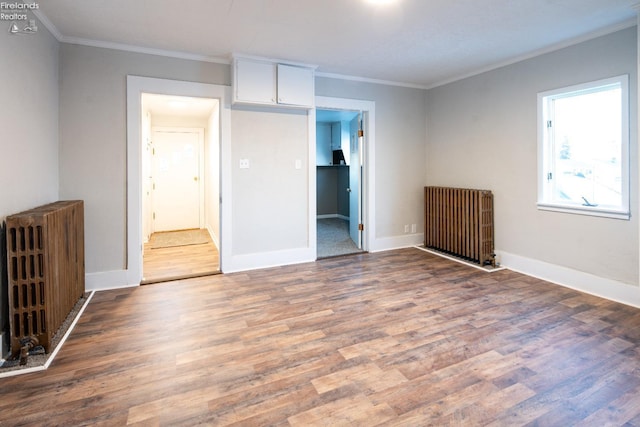 unfurnished bedroom featuring radiator, crown molding, and hardwood / wood-style flooring