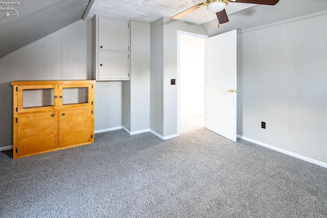 additional living space with vaulted ceiling, ceiling fan, and dark carpet