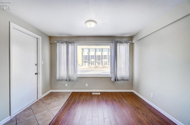 spare room with tile patterned floors