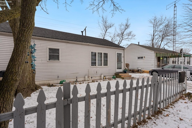 view of snow covered rear of property